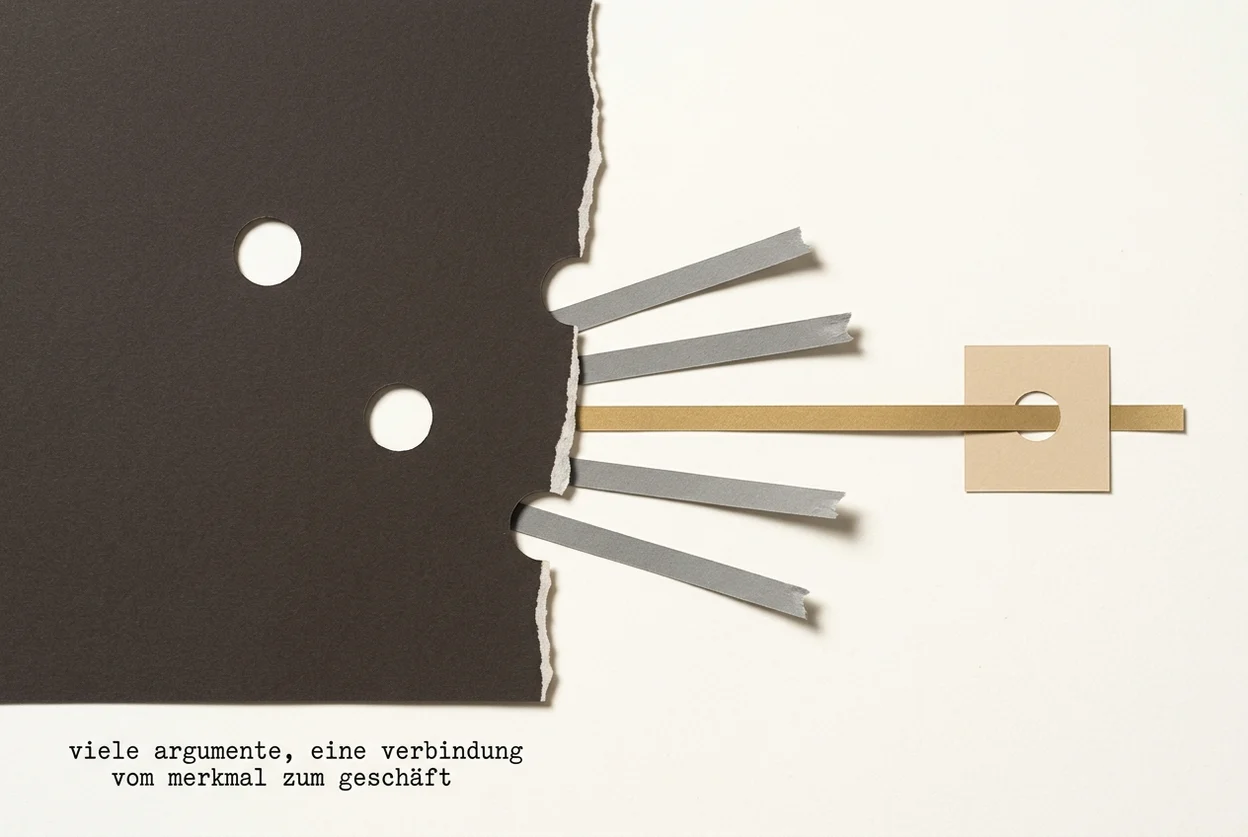 Cut-paper collage: a large, very dark sheet with punched holes, bounded on the right by a hand-torn edge. Five narrow paper strips run right across the pale ground; four grey ones end frayed in the open, the golden one alone carries on and through a hole in a small sand-coloured square. The caption is in German.
